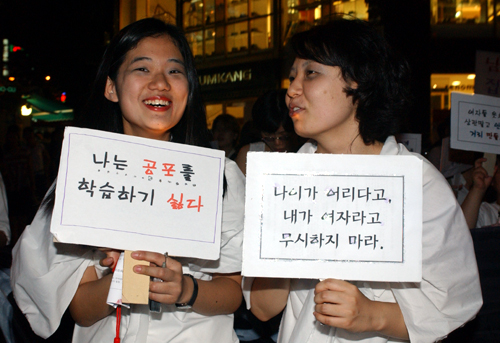 '달빛시위' 참가자들이 하얀소복에 귀신분장을 한채 구호가 적힌 피켓을 들고 시민들의 참여를 독려하고 있다. 